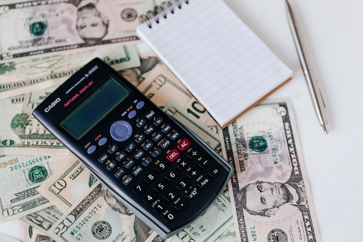 Calculator and money representing bankruptcy filing costs